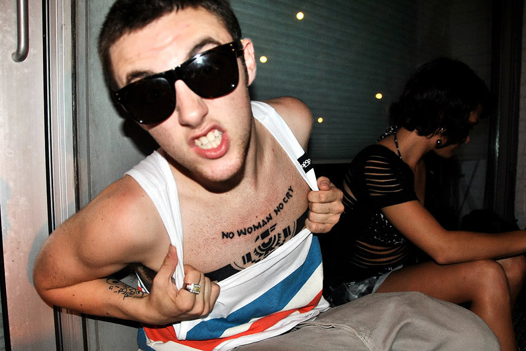 Mac Miller Is Having Tattoos In His Hand And Wearing White Shirt
